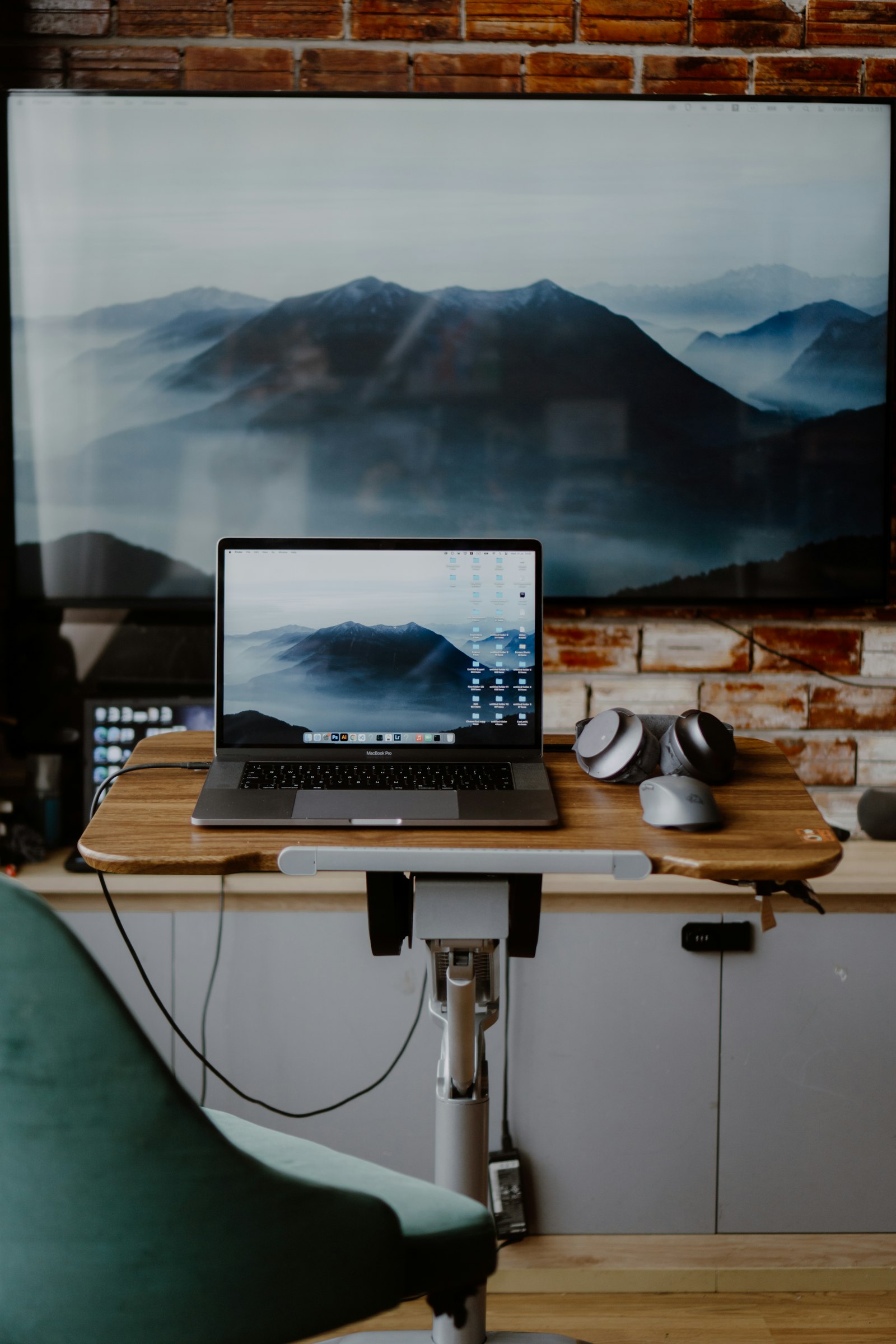 A practical desk setup with a laptop and mountain view